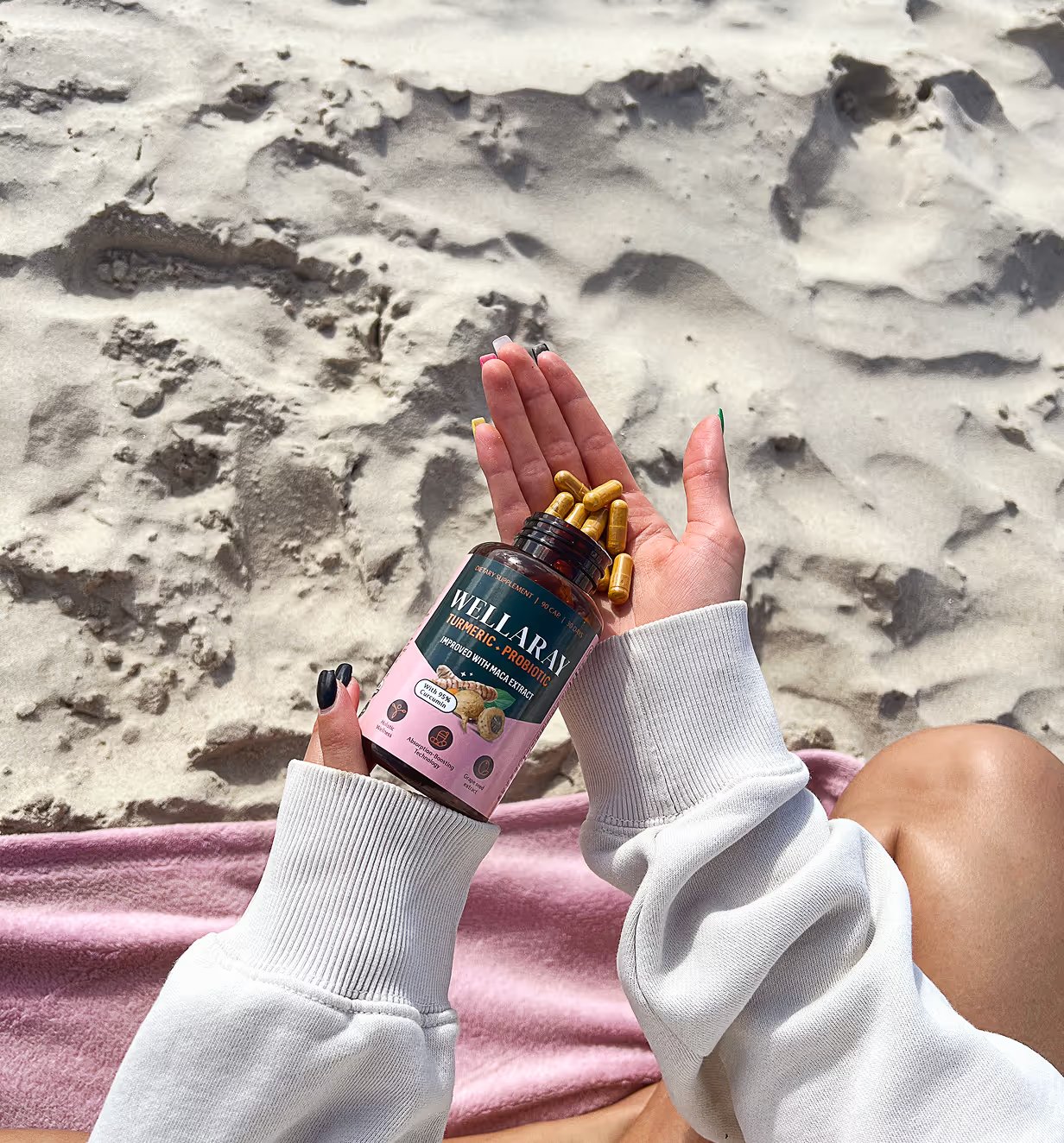 Turmeric + Probiotic capsules held in the sun